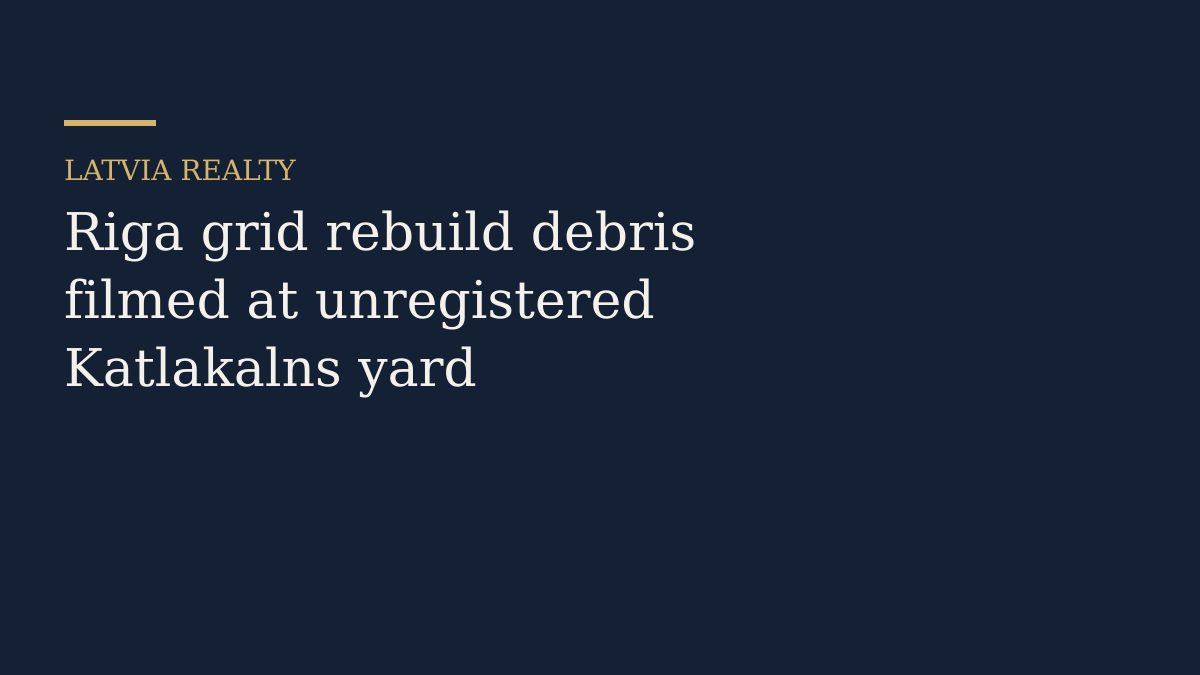 Piles of mixed concrete and brick rubble inside a fenced yard with heavy machinery nearby.